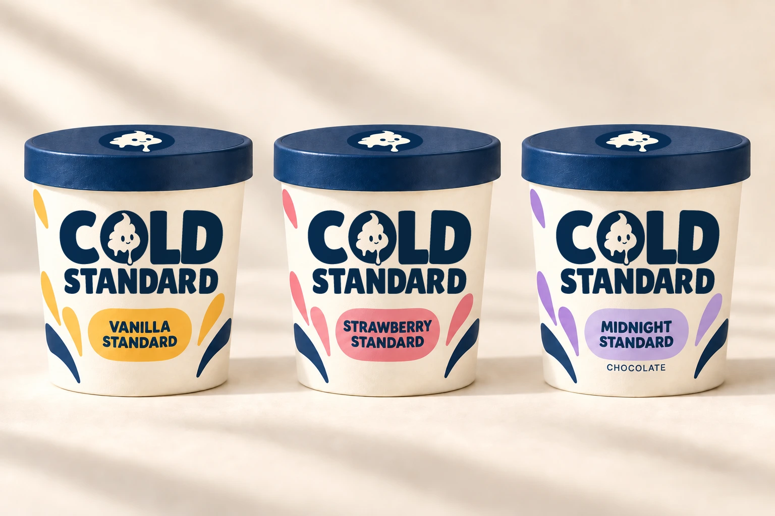 Concept visualization of three cream Cold Standard pints with navy lids in a row: Vanilla Standard with yellow drips, Strawberry Standard with pink drips, and Midnight Standard, chocolate, with lavender drips.